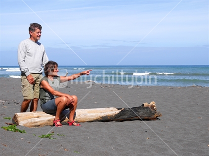 An older couple resting on a Taranaki beach