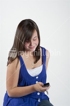 13 year old teenage girl texting on cell phone