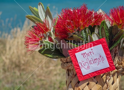 Pohutukawa flowers in woven basket with Meri Kirihimete tag