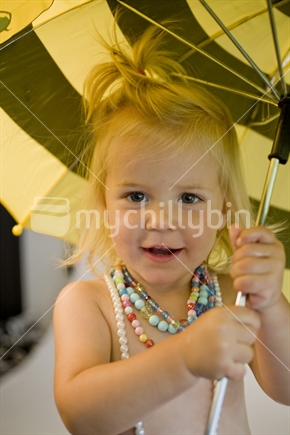 Young girl with necklaces and umbrella