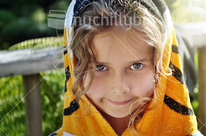 A child wearing a tiger beach towel (selective focus)