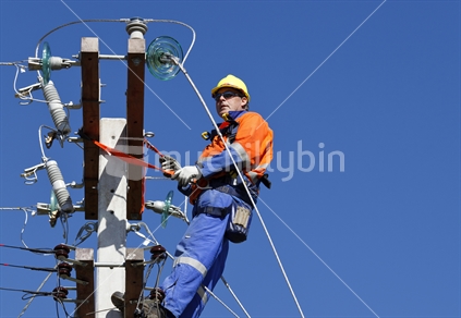 Linesman working on connecting new power lines.