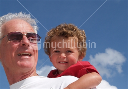 Grandfather and son, enjoying time under summer sky, NZ