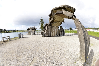 A different perspective of the stone arch sculpture with canoe sculpture in the background.  Overlooking Whangarei Town basin and harbour.