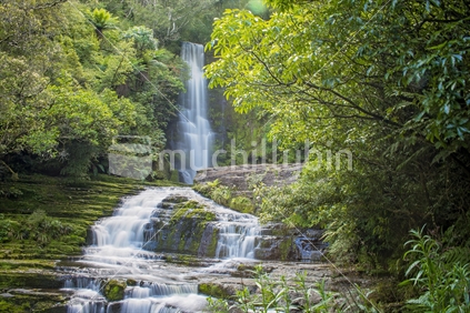 McLean Falls in the Catlins region of Southland, New Zealand - motion blur with water for a silky appearance, and with trees.