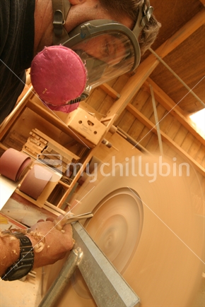 Close up of man sanding on an orbital sander in a workshop