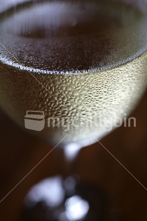 Close up of chilled white wine glass