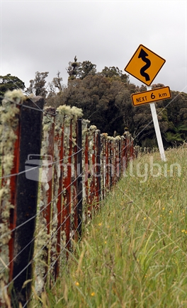 Rustic wooden fence & road sign