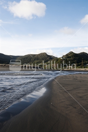 Stream at Piha beach with hills, New Zealand