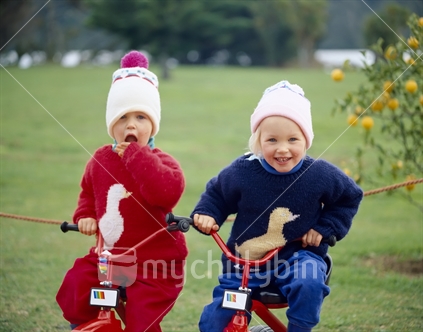 Twins having fun on their bikes
