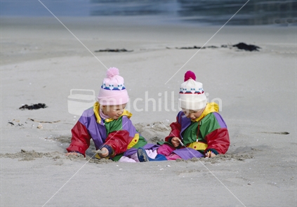 Twins having fun at the beach