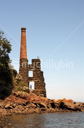 Exploring; the chimney of the old Copper Mine on Kawau Island, Auckland, New Zealand. 