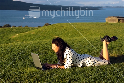 Young woman working on Laptop on Devonport's Mt. Victoria