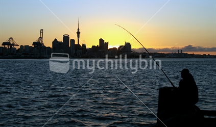 Person fishing at sunset on Devonport Wharf