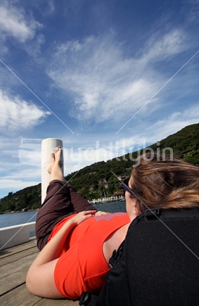 Young woman relaxing on jetty
