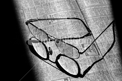 Reading glasses on a newpaper