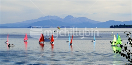 Yachts becalmed on Lake Taupo with mountains in background, New Zealand