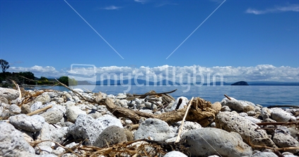 Lake Taupo pumice beach with Tongariro National Park mountains in background