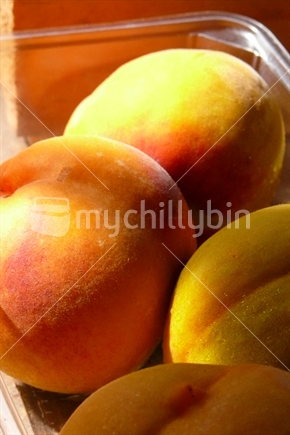 Fresh peaches in dappled sunlight
