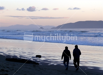 Winter's evening with two people strolling along Waikanae Beach, Horowhenua