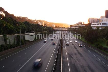 Cars travelling north into better weather on a Wellington motorway, at dawn.
