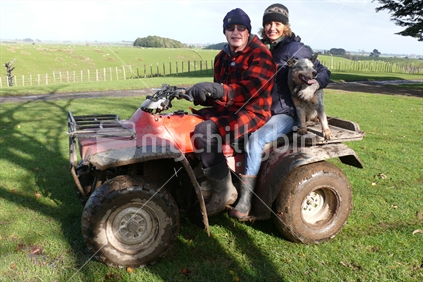 A farming couple on quad bike