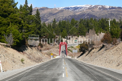 Road leading down to The Red Bridge (one lane), near Wanaka, New Zealand.