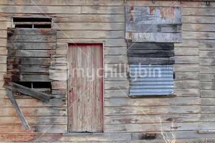 Old timber building with corrugated iron patches.