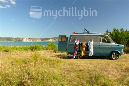 Retro campervan with swimming towels drying on clothesline
