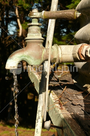 Old rustic tap with wooden handle