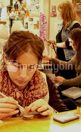 Woman working on contemporary jewellery piece (focus face)