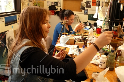Contemporary jewellers working on pieces in workshop