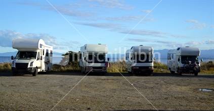 A row of campervans in freedom camp