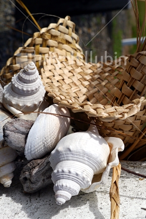 Closeup image of part of a roadside shell and woven flax ornament.
