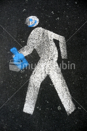 Painted figure or a man on pavement, with added chalked smiley face and bottle.