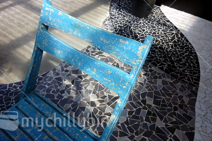 Rustic outdoor chair, on mosaic paving