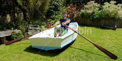 Man tries out new boat on front lawn, at Christmas time