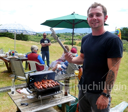 Young man showing off his barbequing skills