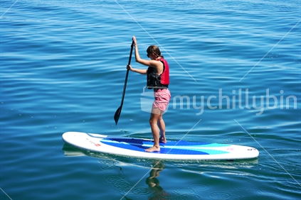 Young woman on a paddle board