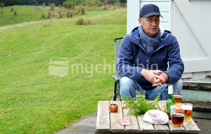 Middle aged man waiting for his winter barbequed lunch 