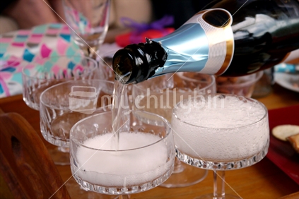 Champagne being poured into glasses for a celebration