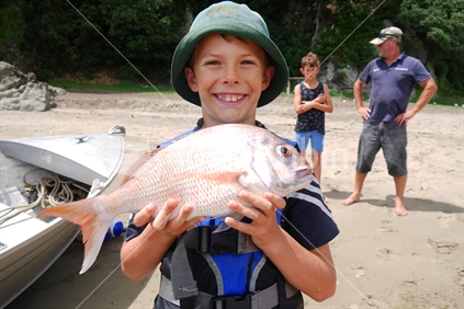 A boy catches his first snapper