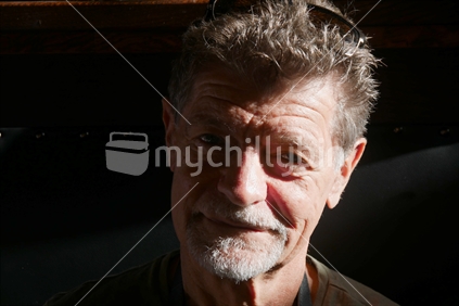 Man in his 60's smiling at the camera