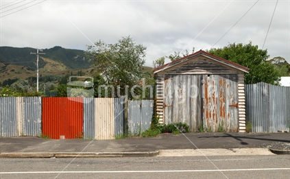 Old corrugated fence and wooden garage