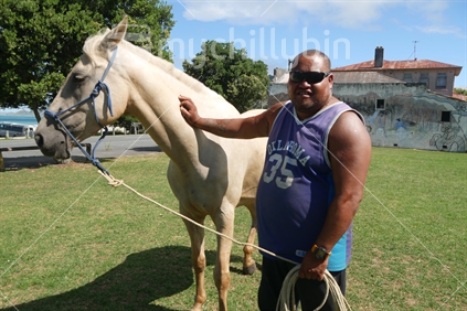 Resident of a small town in New Zealand with his horse