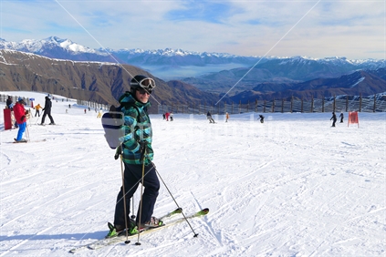 Middle aged male skier, with Cardrona Ski field in background