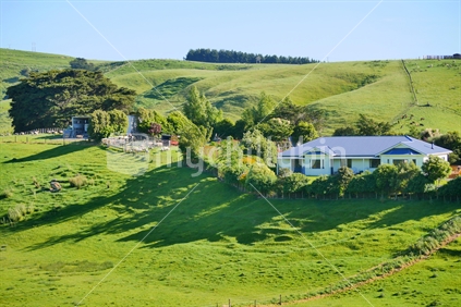 Farm house surrounded by lush pasture