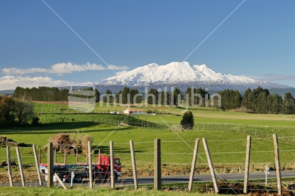 Mount Ruapehu with lush countryside and logging truck in the foreground