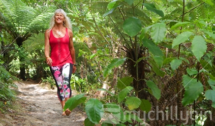Woman walking on bush track in barefeet