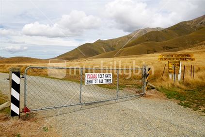 Closed gate on dirt road in remote South Island